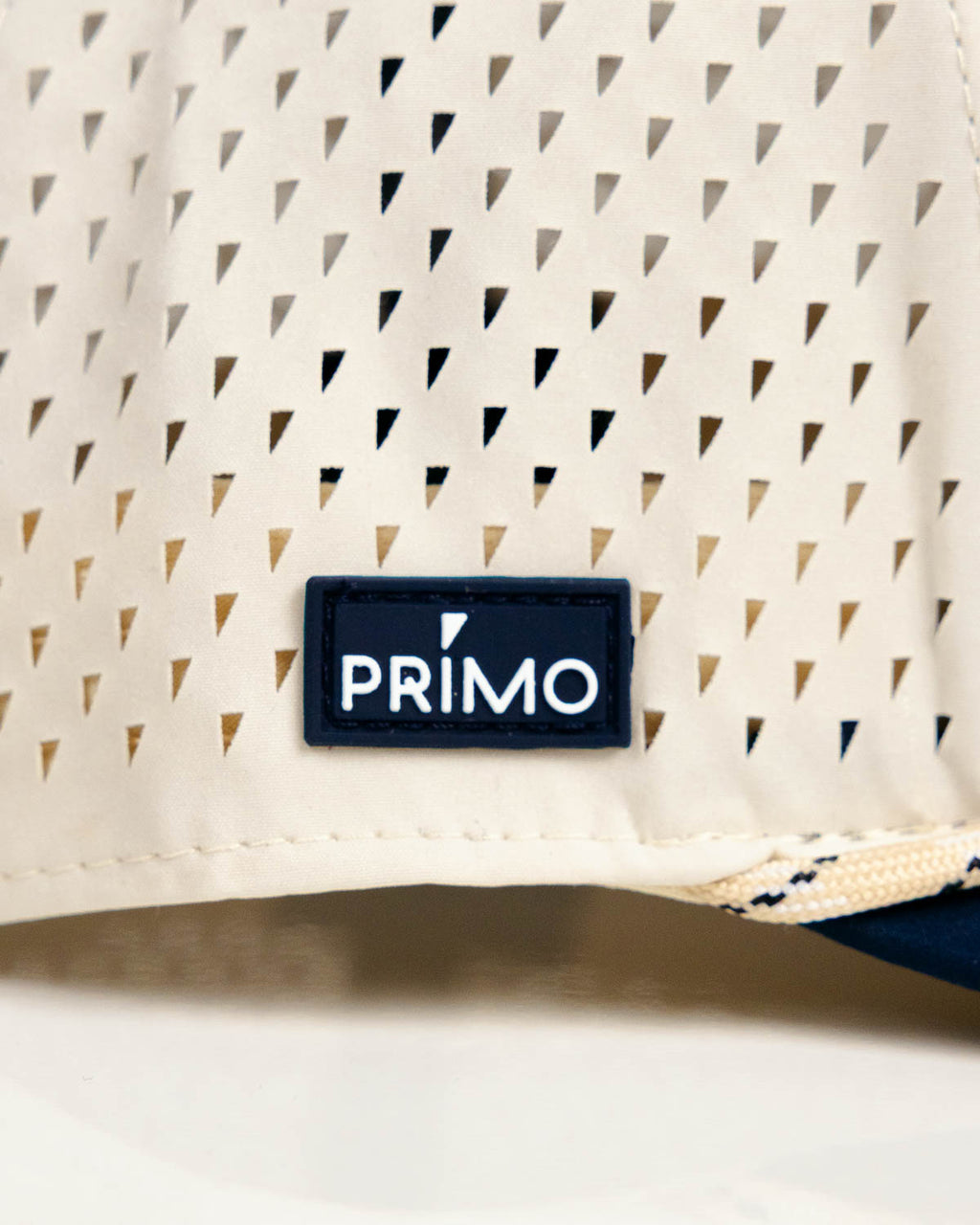 Primo Golf Hat Cream Navy — perforated side panel with Primo rubber patch