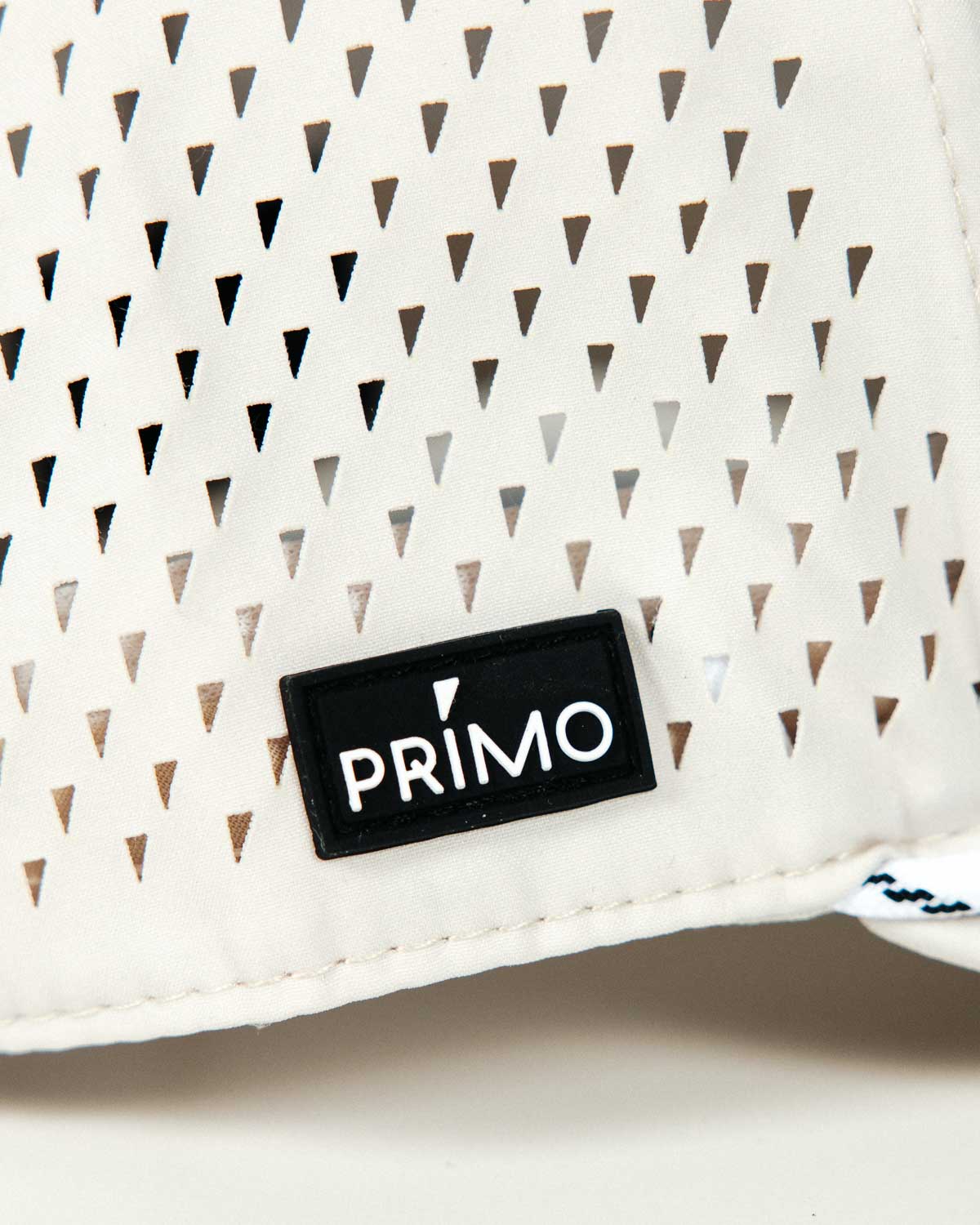 Primo Upside Down Hat Cream — interior branded sweatband with repeating Primo logo