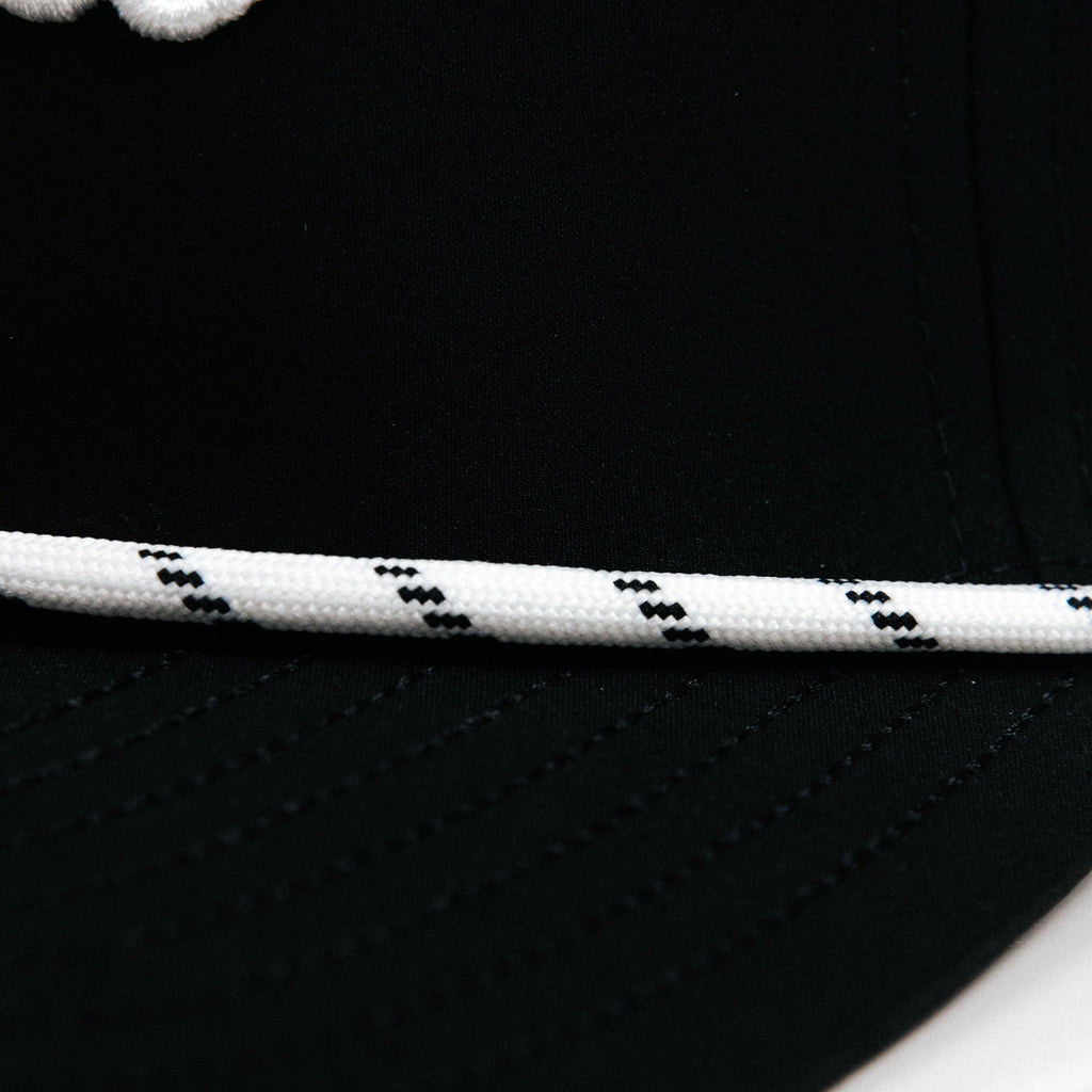 Primo Cursive Snapback Hat Black — perforated crown with Primo logo pattern