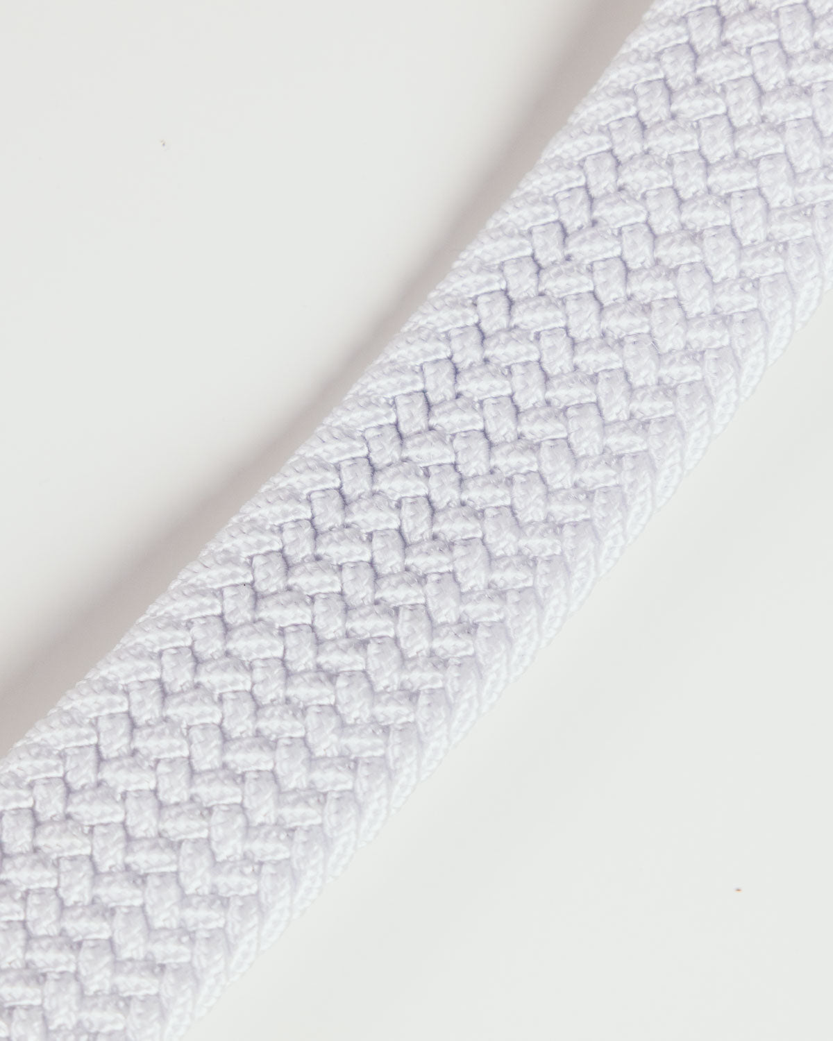 Primo Braided Golf Belt White — angled coiled view with buckle