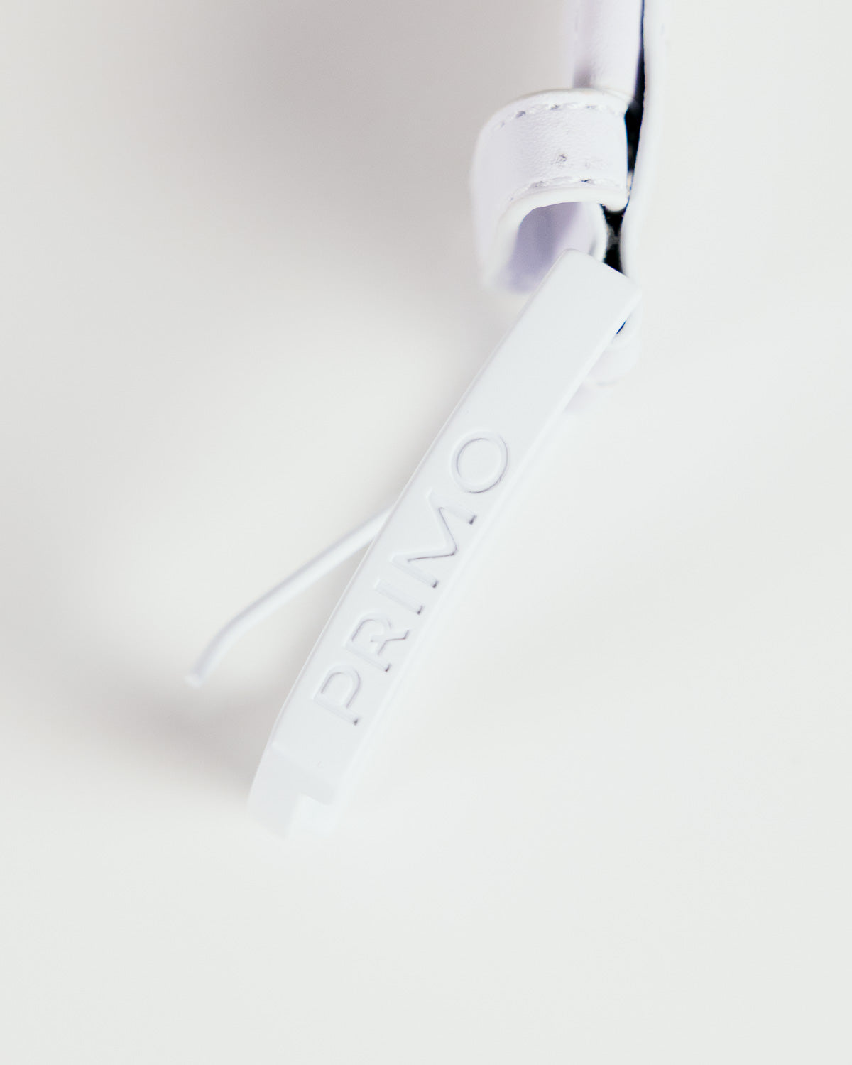 Primo Braided Golf Belt White — buckle logo stamp close up